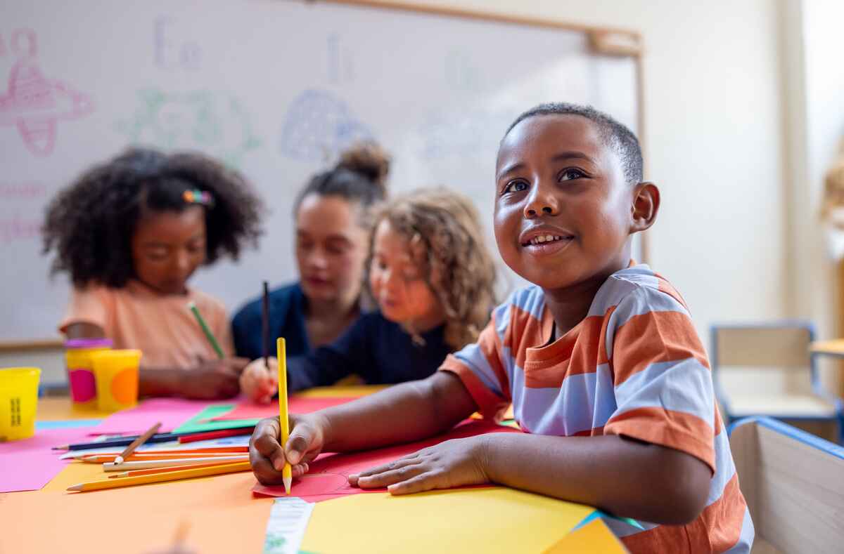Little boy drawing in class