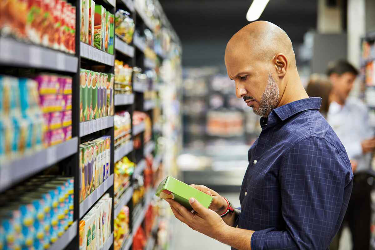 man reads a nutrition label 