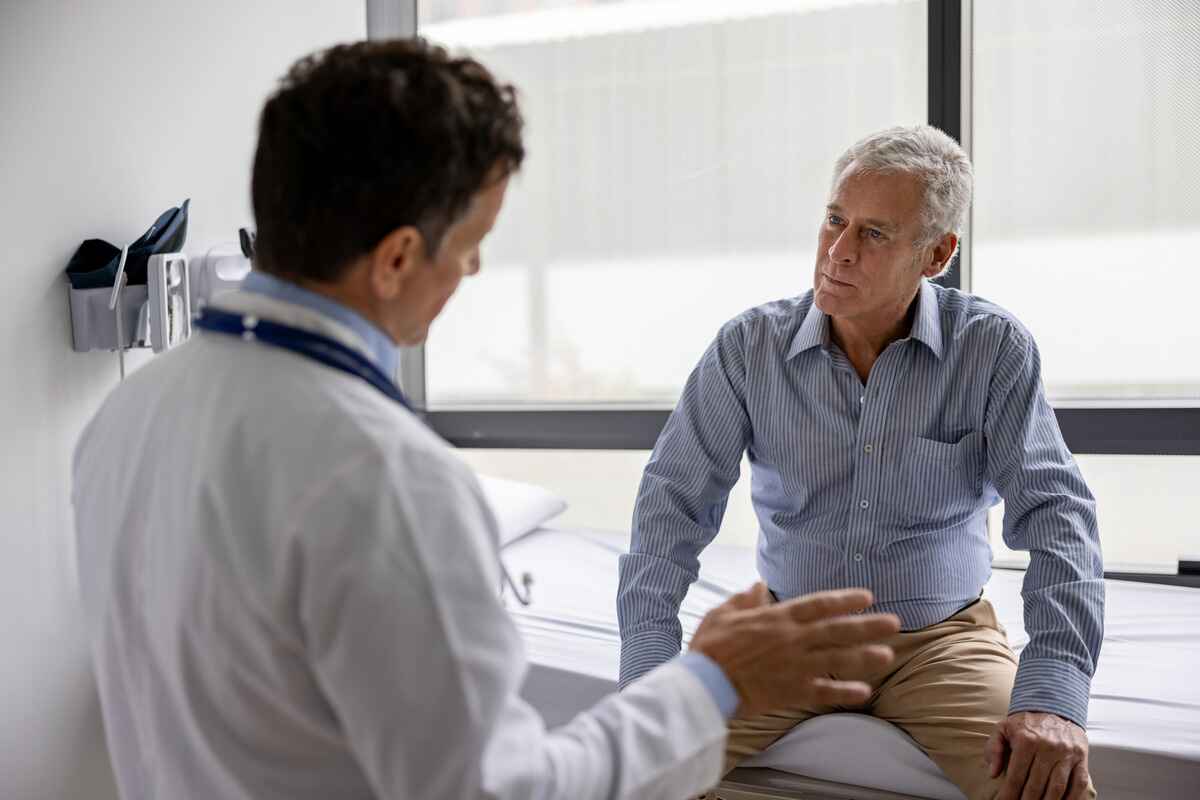 Doctor talks with patient about prostate cancer treatment