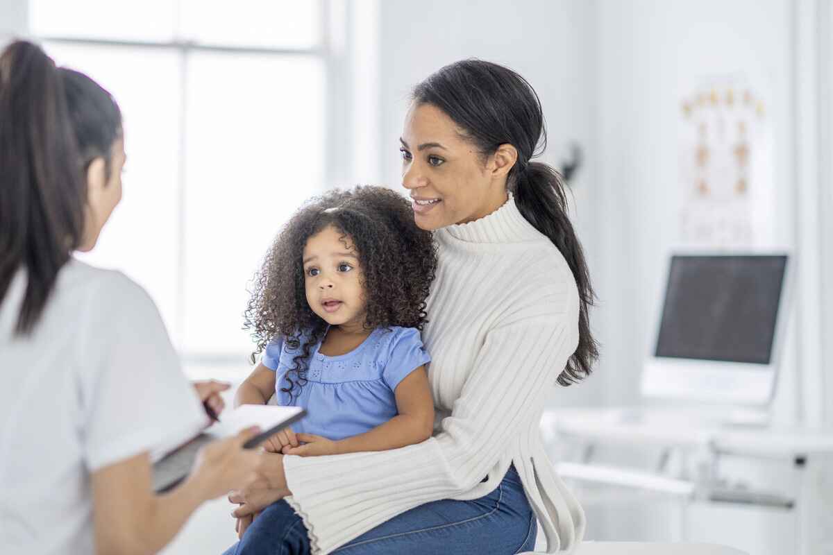 Mother and daughter speak with a doctor