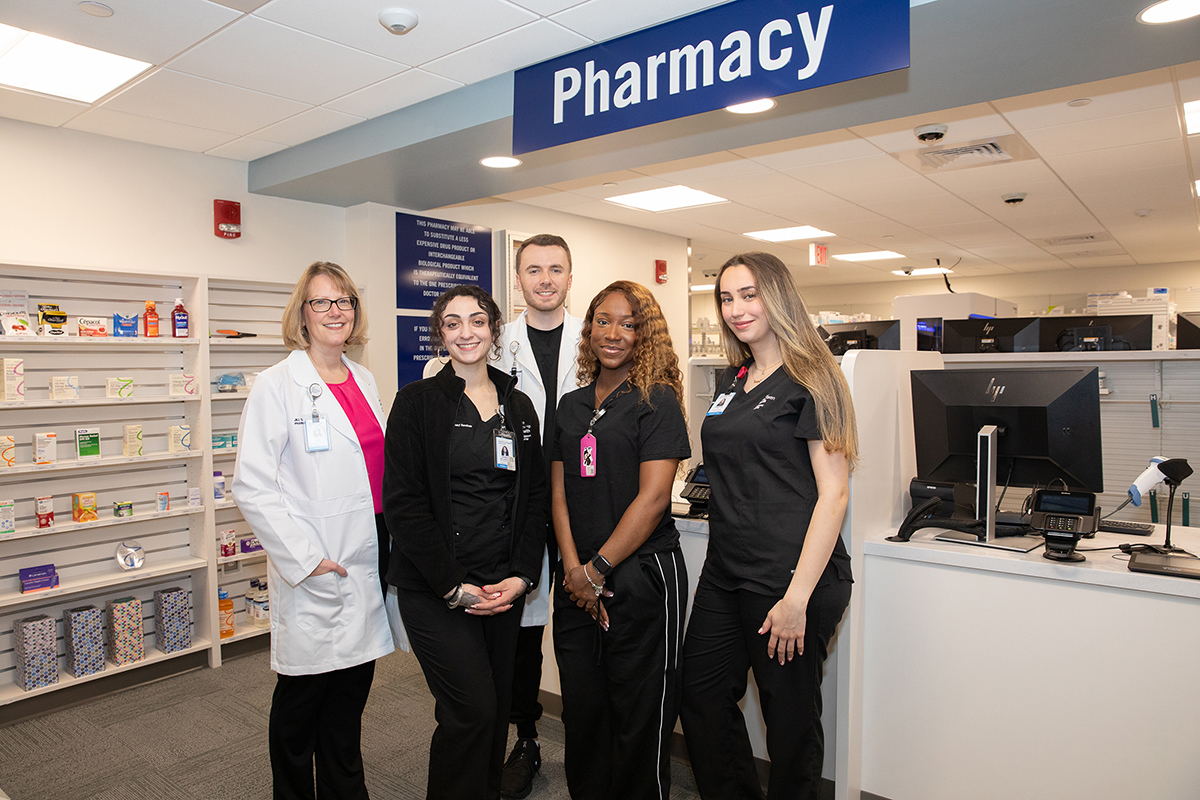 bridgeport hospital pharmacy workers in uniform, posed at a pharmacy setting